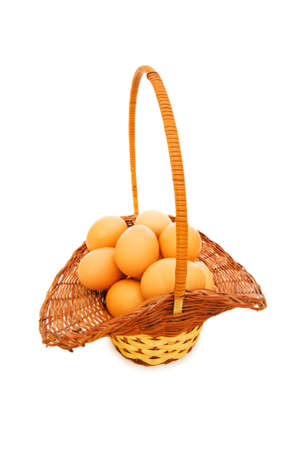 Basket full of eggs isolated on whiteの写真素材