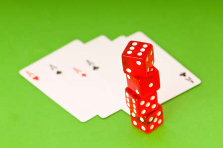 Dice and 4 aces on green backgroundの写真素材