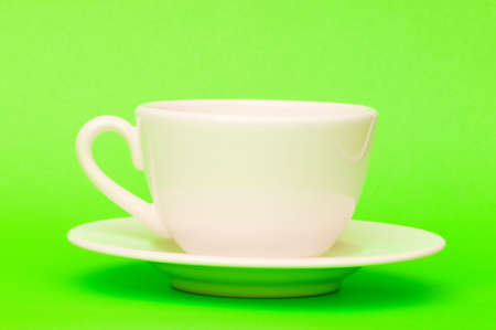 White cup isolated on the green backgroundの写真素材