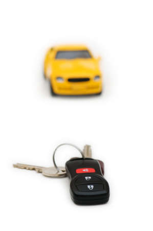 Car keys and car at background isolated on whiteの写真素材