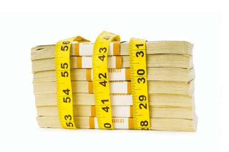 Financial concept - measuring money isolated on whiteの写真素材