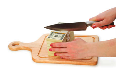Money concept - cutting dollars with the knifeの写真素材