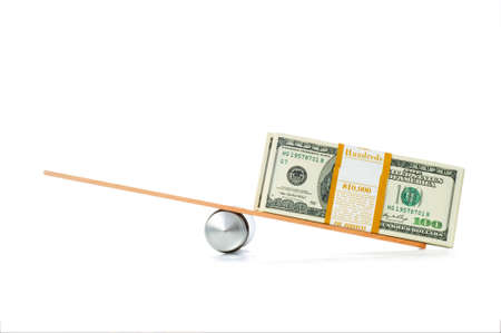 Financial concept - balance between coins and paper moneyの写真素材