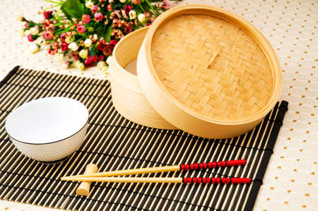 Chopsticks and bowl on the bamboo matの写真素材