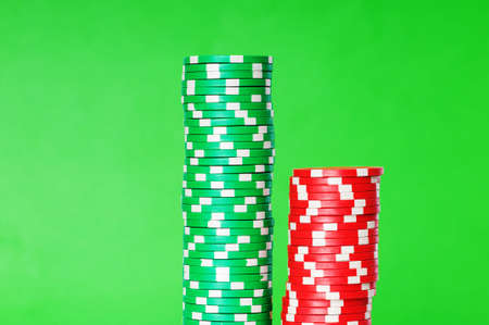 Stack of casino chips against green backgroundの写真素材