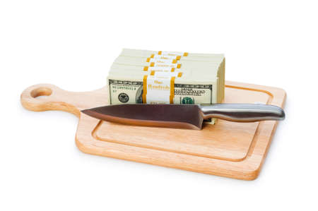Money concept - cutting dollars with the knifeの写真素材