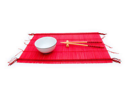 Chopsticks and bowl on the bamboo matの写真素材