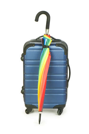 Travelling concept with case and umbrella on the whiteの写真素材