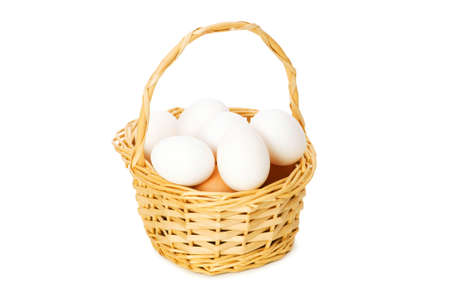 Basket full of eggs isolated on whiteの写真素材
