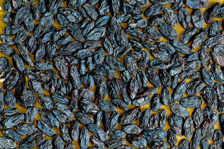 Background made of dark dried raisinsの写真素材