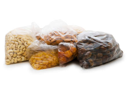 Various dry fruits in the bags on whiteの写真素材