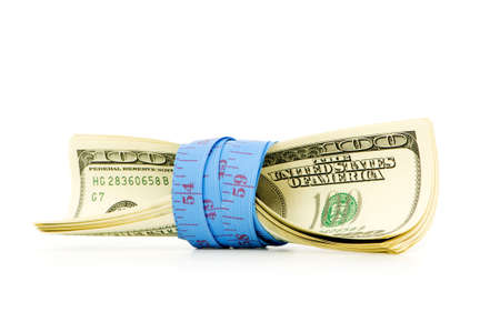 Financial concept - measuring money on whiteの写真素材