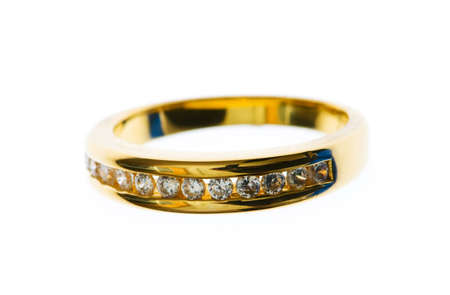 Golden ring with  diamond isolated on the whiteの写真素材