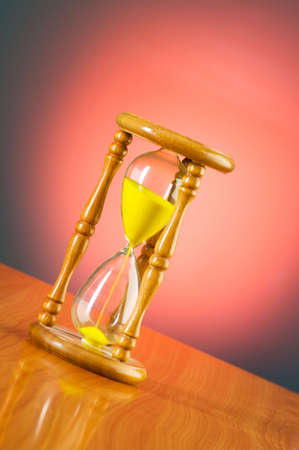 Time concept with hourglass against background