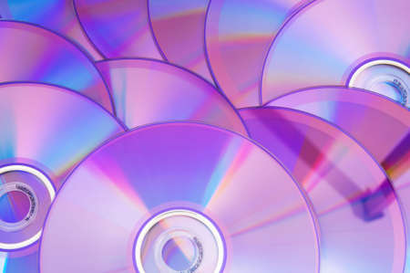 Many DVD's arranged at the white backgroundの写真素材