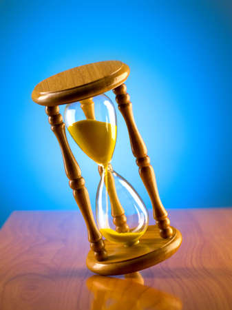 Time concept with hourglass against background