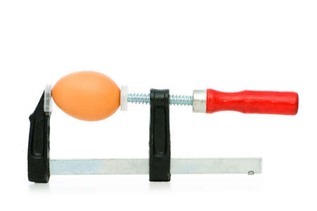 Strength concept with egg and clamp on whiteの写真素材