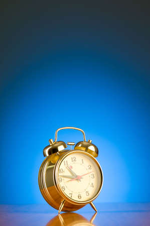 Alarm clock against colourful backgroundの写真素材