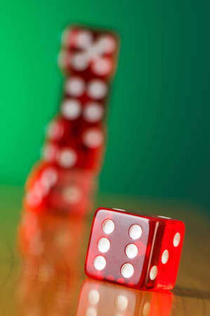 Stack of red casino dice against gradient background