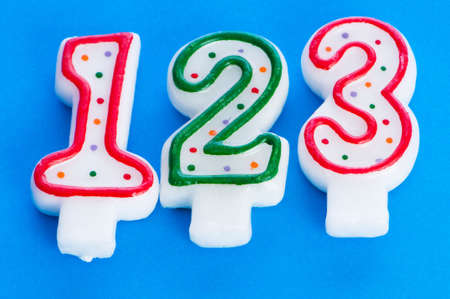 Birthday candles against colourful backgroundの写真素材