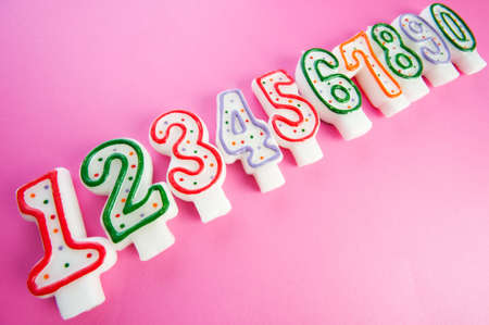 Birthday candles against colourful backgroundの写真素材
