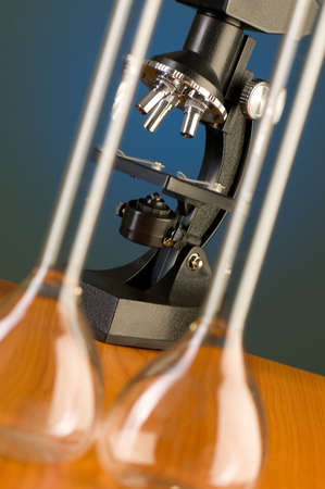 Microscope against blue gradient background