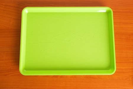 Green tray on the wooden tableの写真素材