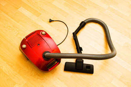 Vacuum cleaner on the wooden floorの写真素材
