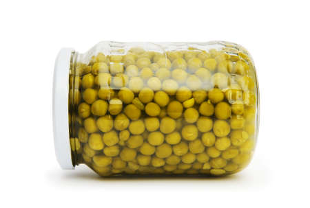Green peas in glass jar isolated on whiteの写真素材