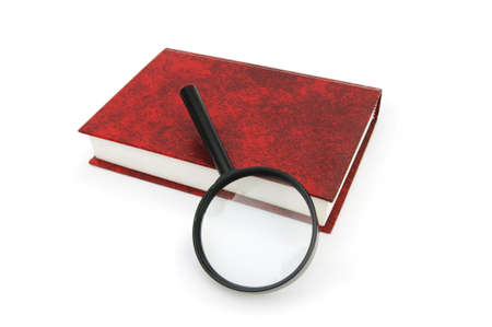 Magnifying glass over the stack of booksの写真素材