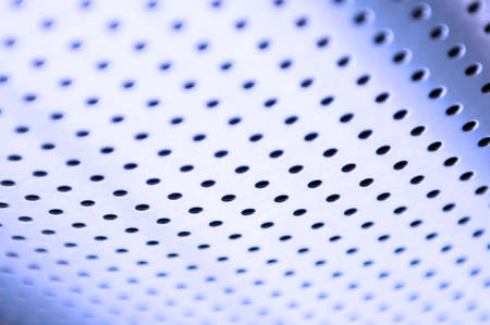Polished metal surface with the small holes の写真素材