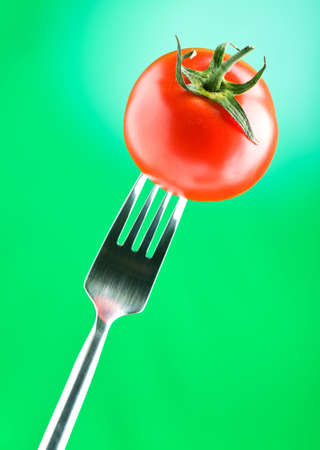 Red tomato against gradient backgroundの写真素材