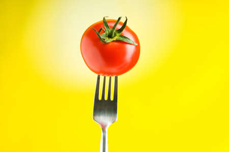 Red tomato against gradient backgroundの写真素材
