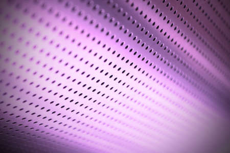 Polished metal surface with the small holes の写真素材