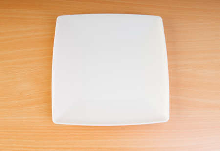 Empty plate on the wooden tableの写真素材