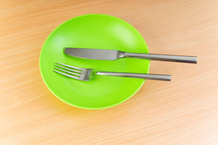 Plate with utensils on wooden tableの写真素材