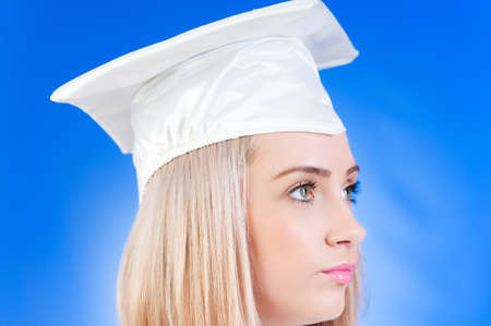 Happy graduate against colourful backgroundの写真素材