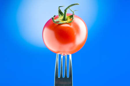 Red tomato against gradient background