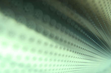 Polished metal surface with the small holes の写真素材