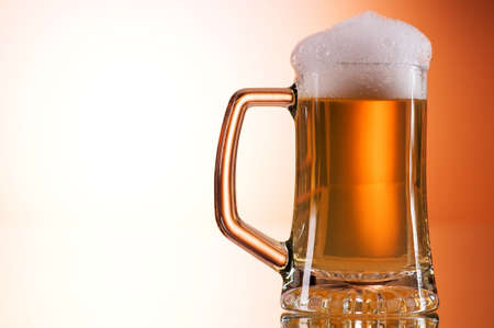 Beer glasses against the colorful gradient backgroundの写真素材