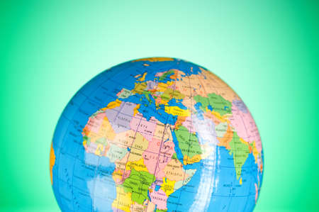 Globalisation concept - globe against gradient colorful backgroundの写真素材