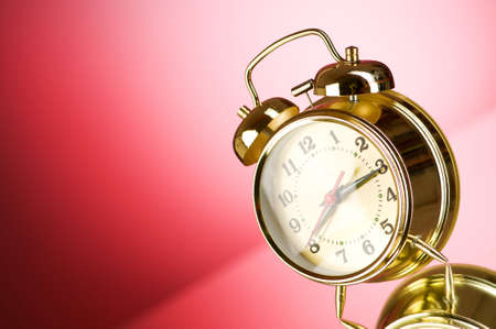 Time concept - alarm clock against colorful backgroundの写真素材