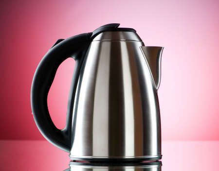 Shiny kettle against the colorful gradient backgroundの写真素材
