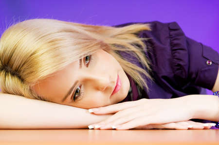 Attractive blond girl against colourful backgroundの写真素材
