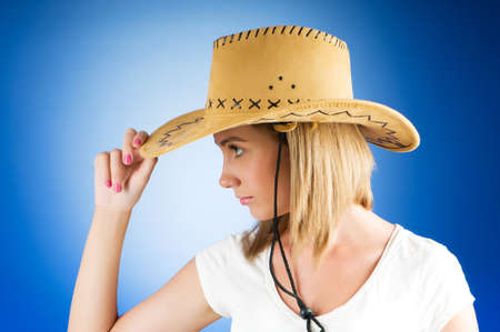 Young girl wearing cowboy hat in the studioの写真素材
