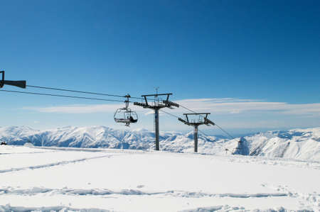Ski lift chairs on bright winter dayの写真素材