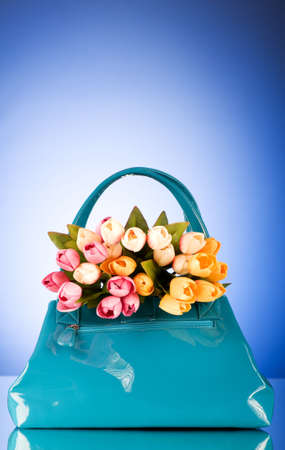 Bag and flowers against the colorful backgroundの写真素材