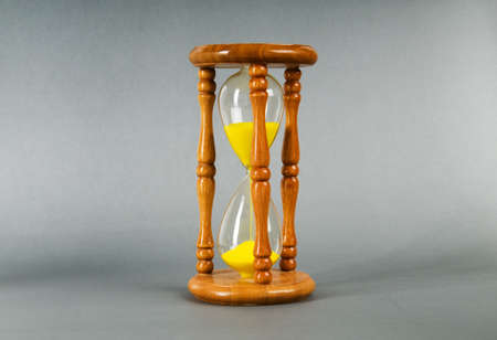 Time concept - hourglass against the gradient background