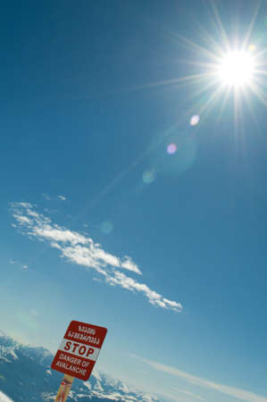 Avalanche sign and mountains at the backgroundの写真素材