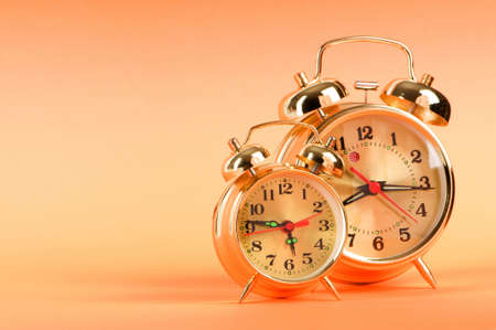 Time concept - alarm clock against colorful backgroundの写真素材